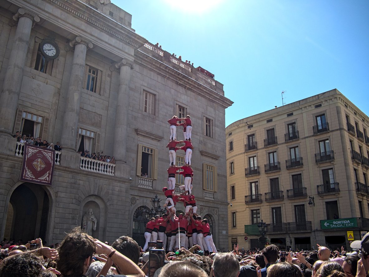 Traditional Catalan human tower, or castell, being performed by castellers in front of Barcelona City Hall during a festival.