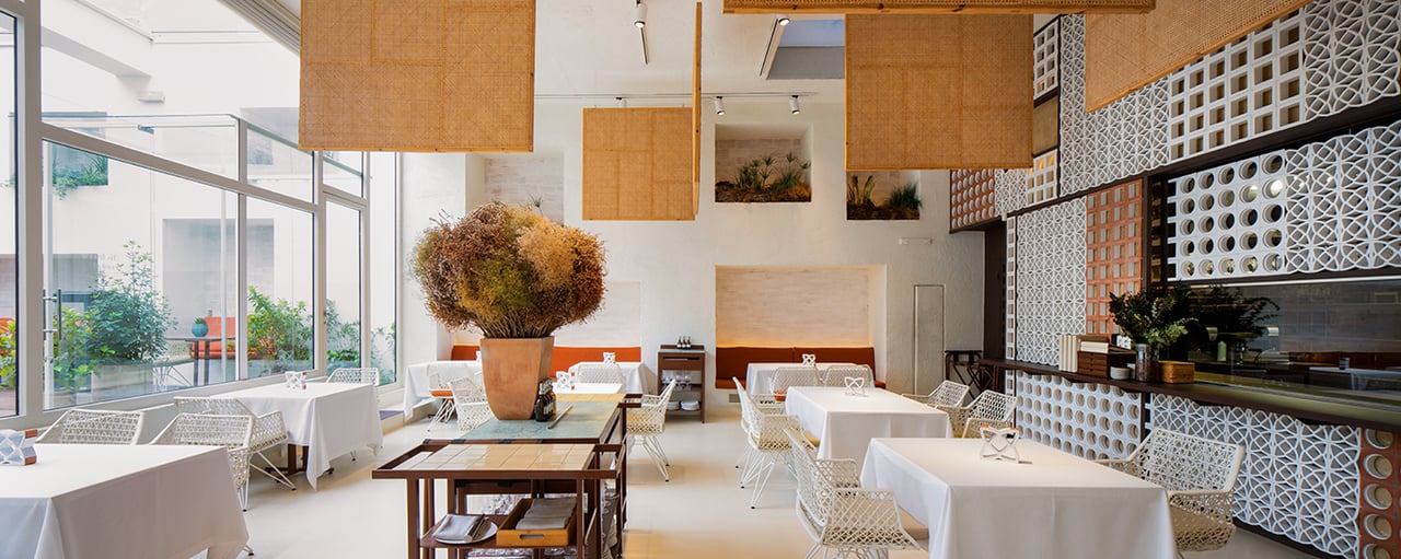 The elegant interior of Disfrutar, a Michelin-starred restaurant in Barcelona, with modern decor and artistic design elements.