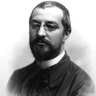 A black-and-white portrait of Josep Puig i Cadafalch, a notable Catalan architect and politician known for his contributions to modernist architecture in Barcelona, including Casa Amatller.
