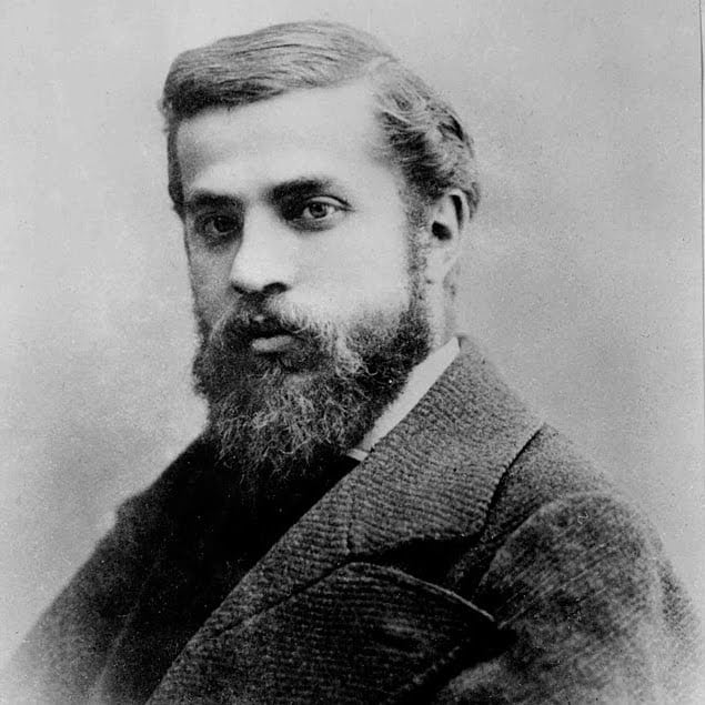 A black-and-white portrait of Antoni Gaudí, the renowned architect known for his iconic works in Barcelona, including the Sagrada Família and Park Güell.