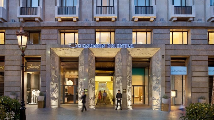Grand entrance of the Mandarin Oriental Hotel in Barcelona, showcasing its modern architecture and luxury ambiance.