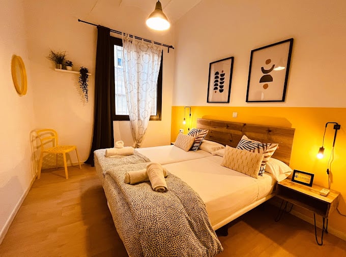A room with a double bed at Bed & Bike Hostel in Barcelona.