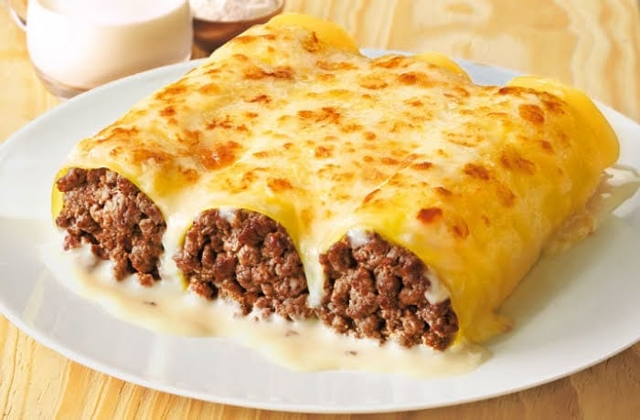 Plate of Canelones, a traditional Catalan dish of pasta tubes stuffed with minced meat, covered in béchamel sauce and cheese.