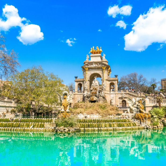 View of the beautiful fountain in Parc de la Ciutadella, Barcelona, with clear blue skies and lush greenery.