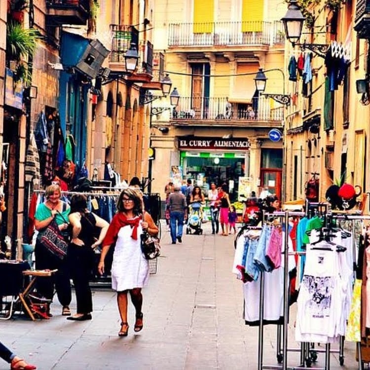 Busy street in the el raval neighborhood, with a bunch of stores