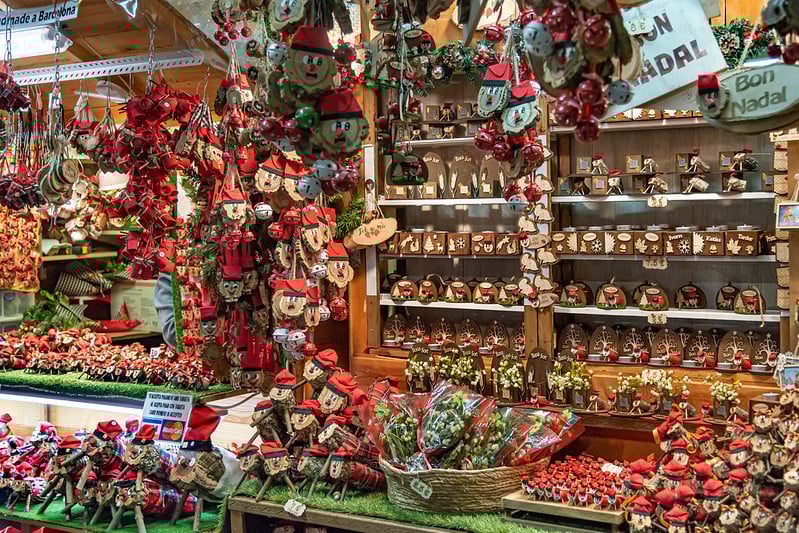 Barcelona Christmas market stall with Caga Tió decorations.