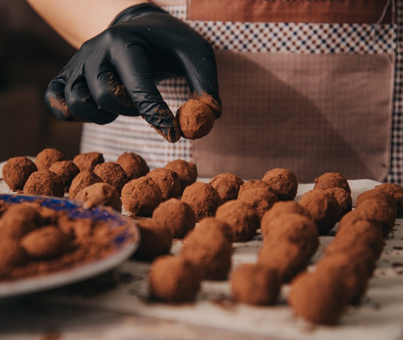 A person preparing chocolate snacks