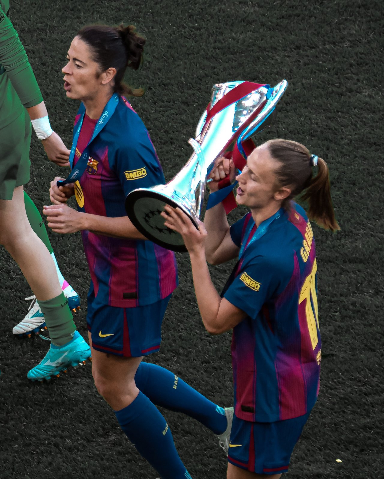 Marta Torrejón and Caroline Graham Hansen celebrate with the UEFA Women's Champions League trophy after the 2026 final