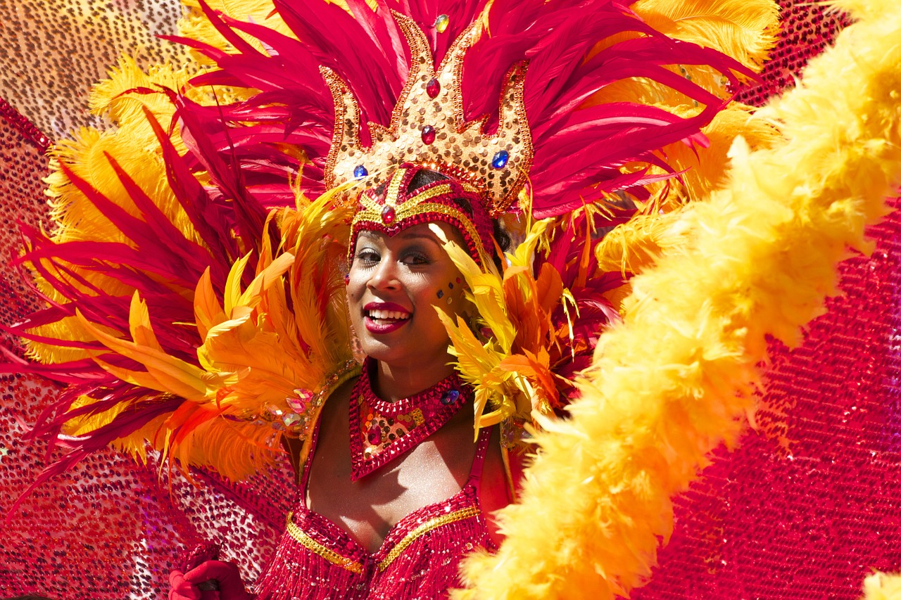 A dancer in a red and yellow feathered costume performing at Barcelona Carnival.
