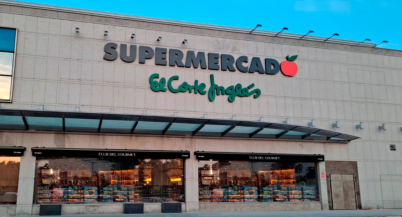 Facade of El Corte Inglés supermarket in Barcelona featuring modern glass windows and bold signage.