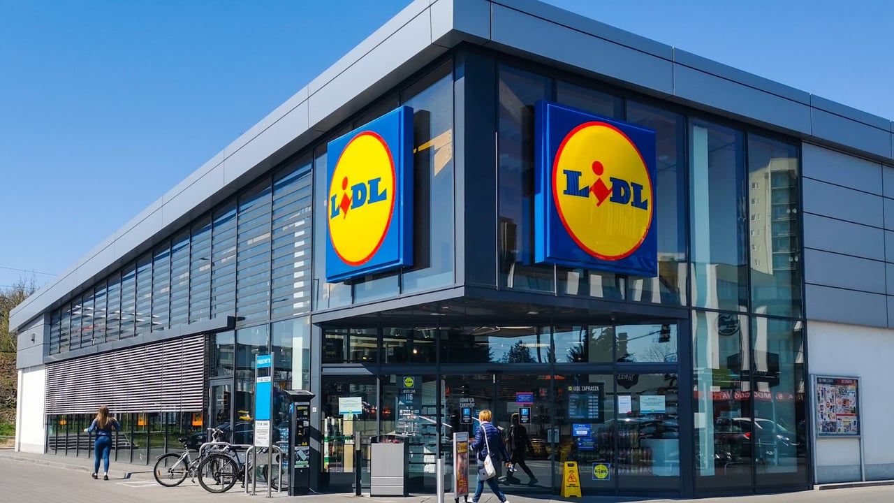 Exterior of Lidl supermarket in Barcelona with large glass windows and the store’s logo prominently displayed.
