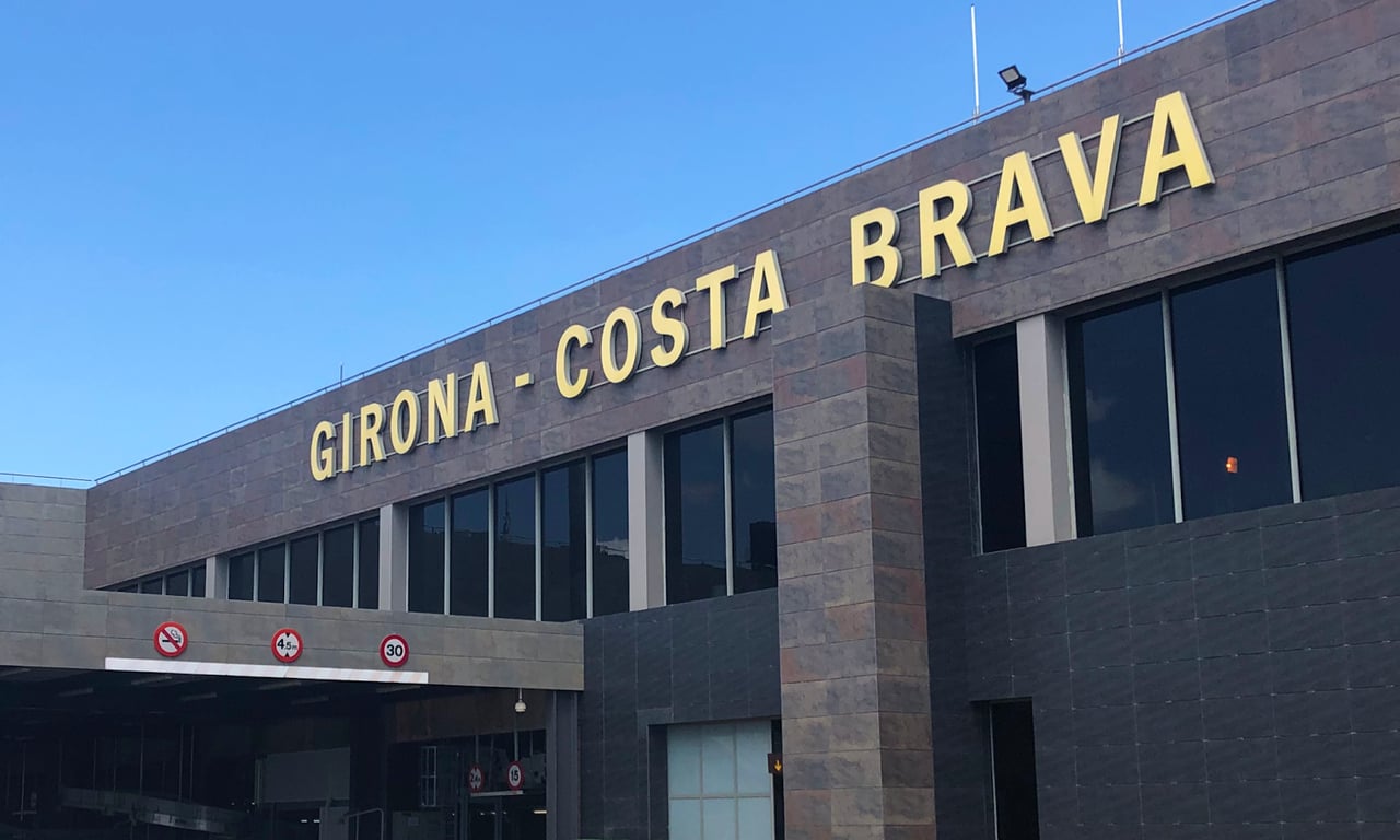 Entrance of Girona-Costa Brava Airport with clear signage on the building.