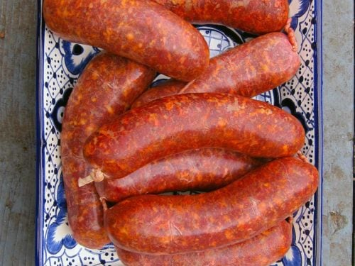 Traditional Spanish chorizo sausages displayed on a decorative ceramic plate.