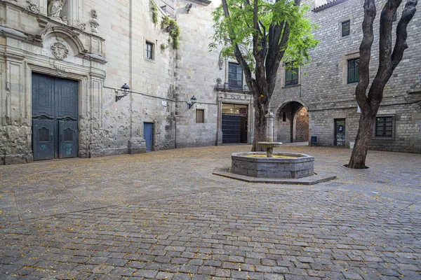 Plaça de Sant Felip Neri in the Gothic Quarter of Barcelona, a quiet cobblestone square with a central fountain and historic buildings.