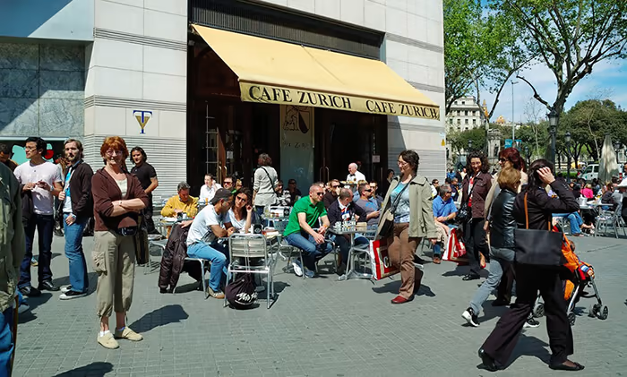 Cafe in Barcelona with people walking around