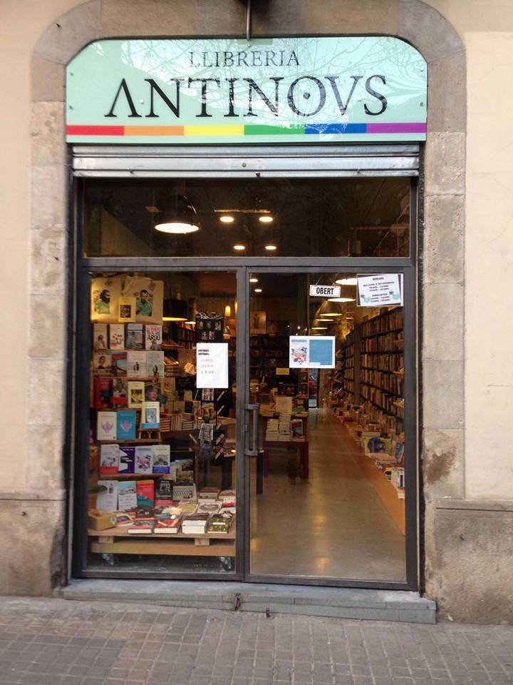 Front view of Antinovs bookstore in Barcelona, showcasing its colorful signage and window display.
