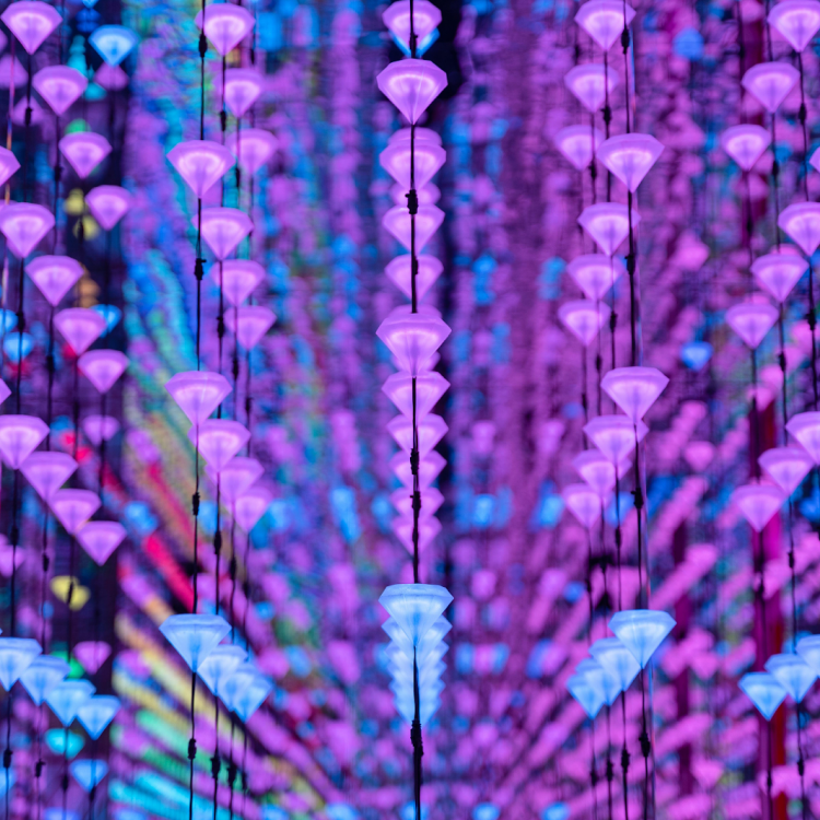 Colorful hanging lights creating a mesmerizing pattern inside the Moco Museum in Barcelona.